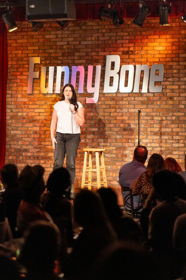 A comedian performing under the FunnyBone sign in 2025